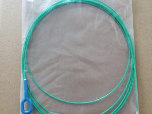 Green circular object in clear plastic packaging